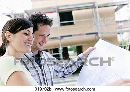 portrait of couple in front their new home with plan View Large Photo Image Stock Image - portrait of couple in front their new home with plan. Fotosearch