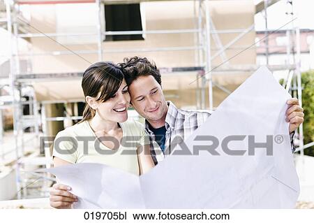 portrait of couple in front their new home with plan View Large Photo Image Stock Image - portrait of couple in front their new home with plan. Fotosearch