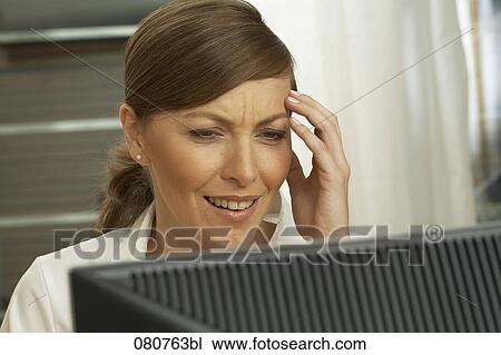 portrait of desperate businesswoman looking at computer View Large Photo Image Stock Image - portrait of desperate businesswoman looking at computer. Fotosearch