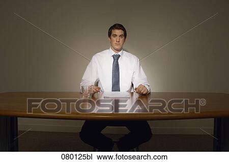 portrait of determined businessman sitting at desk View Large Photo Image Stock Image - portrait of determined businessman sitting at desk. Fotosearch