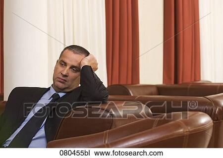 portrait of exhausted businessman sitting in hotel lobby View Large Photo Image Stock Image - portrait of exhausted businessman sitting in hotel lobby. Fotosearch