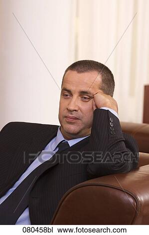 portrait of exhausted businessman sitting in hotel lobby View Large Photo Image Stock Image - portrait of exhausted businessman sitting in hotel lobby. Fotosearch