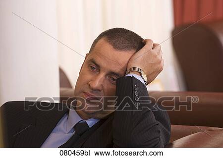 portrait of exhausted businessman sitting in hotel lobby View Large Photo Image Stock Image - portrait of exhausted businessman sitting in hotel lobby. Fotosearch