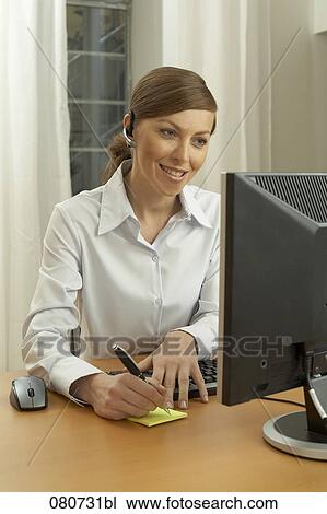 portrait of female call center agent taking notes View Large Photo Image Stock Image - portrait of female call center agent taking notes. Fotosearch