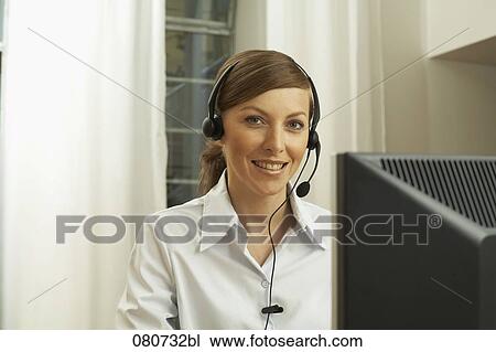 portrait of female call center agent sitting at computer View Large Photo Image Stock Image - portrait of female call center agent sitting at computer. Fotosearch