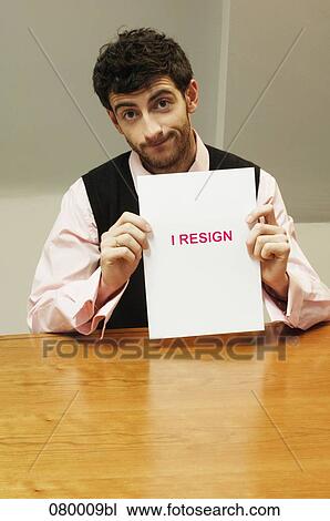 portrait of frustrated businessman sitting at desk holding resign document View Large Photo Image Stock Image - portrait of frustrated businessman sitting at desk holding resign document. Fotosearch