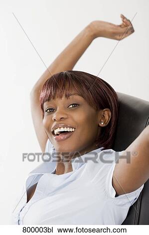 portrait of happy black office worker sitting on chair View Large Photo Image Stock Image - portrait of happy black office worker sitting on chair. Fotosearch