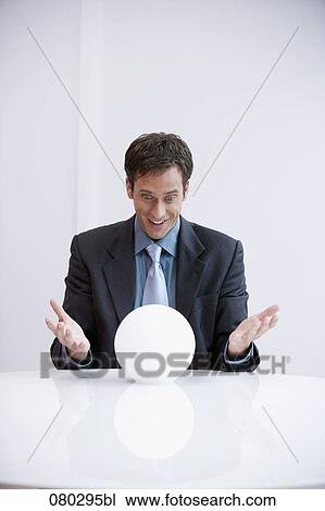 portrait of happy businessman looking into crystal ball View Large Photo Image Stock Image - portrait of happy businessman looking into crystal ball . Fotosearch