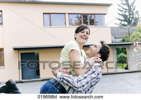 portrait of happy young couple in front of their new home View Large Photo Image Stock Image - portrait of happy young couple in front of their new home. Fotosearch