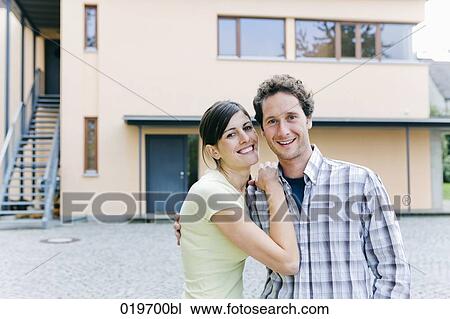portrait of happy young couple in front of their new home View Large Photo Image Stock Image - portrait of happy young couple in front of their new home. Fotosearch