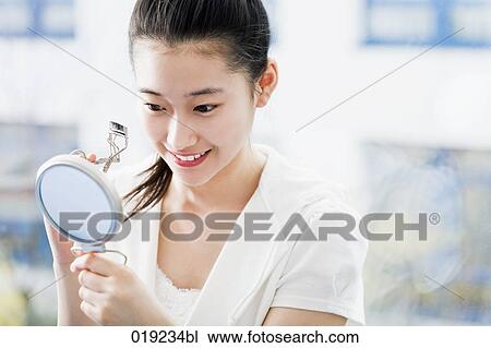 portrait of japanese girl using eyelash curler View Large Photo Image Stock Image - portrait of japanese girl using eyelash curler. Fotosearch