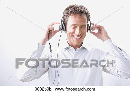 Stock Image - portrait of male call center agent with headset. Fotosearch