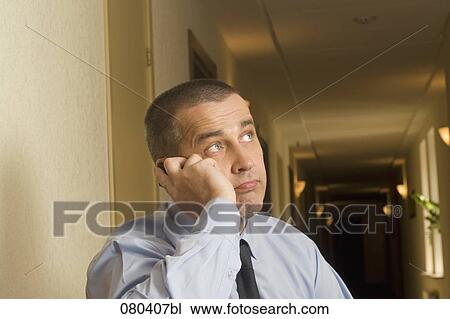 portrait of mature businessman in hotel corridor talking on mobile phone View Large Photo Image Stock Image - portrait of mature businessman in hotel corridor talking on mobile phone. Fotosearch