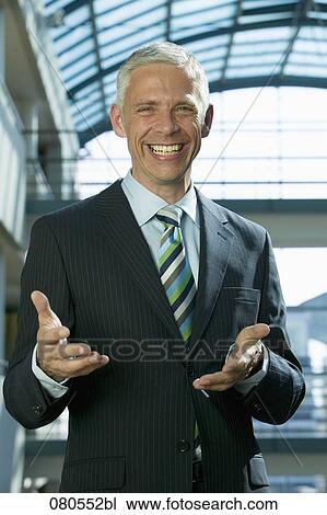 portrait of mature businessman making inviting gesture View Large Photo Image Stock Image - portrait of mature businessman making inviting gesture. Fotosearch