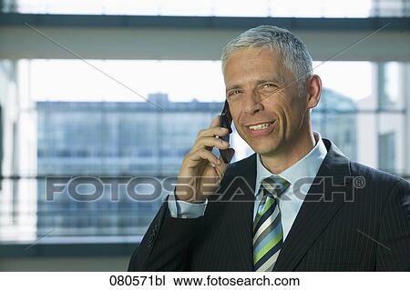 portrait of mature businessman listening to mobile phone View Large Photo Image Stock Image - portrait of mature businessman listening to mobile phone. Fotosearch