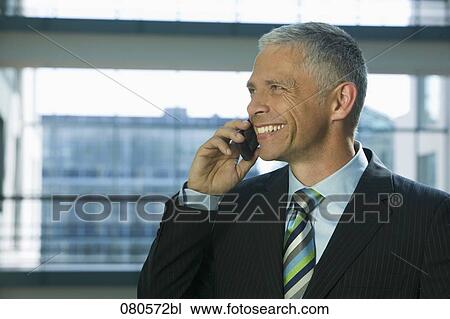 portrait of mature businessman listening to mobile phone View Large Photo Image Stock Image - portrait of mature businessman listening to mobile phone. Fotosearch