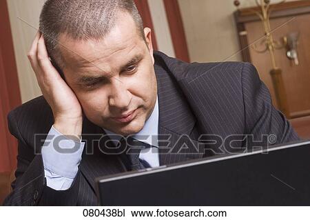 portrait of mature businessman working with laptop computer in hotel lobby View Large Photo Image Stock Image - portrait of mature businessman working with laptop computer in hotel lobby. Fotosearch