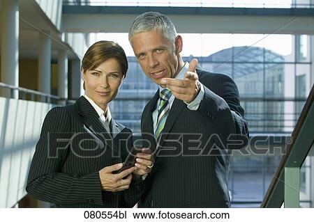 Stock Image - portrait of mature businesswoman and male colleague. Fotosearch