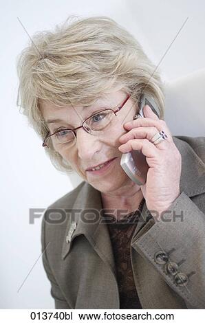 portrait of mature businesswoman listening to her cellphone View Large Photo Image Stock Image - portrait of mature businesswoman listening to her cellphone. Fotosearch