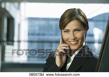Stock Image - portrait of mature businesswoman listening to mobile phone. Fotosearch