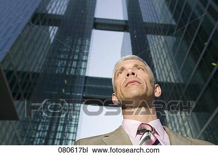 Stock Image - portrait of mature executive in front of office building. Fotosearch