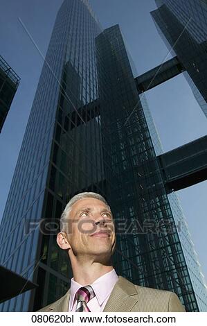 Stock Image - portrait of mature executive in front of office building. Fotosearch