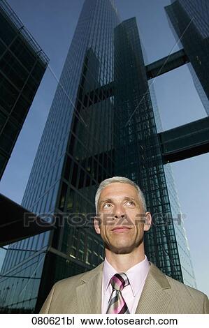 Stock Image - portrait of mature executive in front of office building. Fotosearch