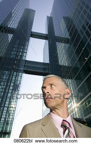 portrait of mature executive in front of office building View Large Photo Image Stock Image - portrait of mature executive in front of office building. Fotosearch