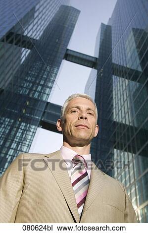 portrait of mature executive in front of office building View Large Photo Image Stock Image - portrait of mature executive in front of office building. Fotosearch