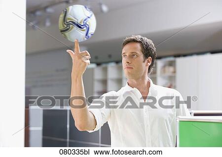 portrait of office worker balancing football on finger View Large Photo Image Stock Image - portrait of office worker balancing football on finger. Fotosearch