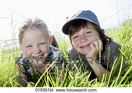 portrait of sister and brother reaxing in grass View Large Photo Image Stock Image - portrait of sister and brother reaxing in grass. Fotosearch