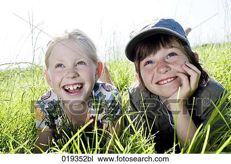 portrait of sister and brother reaxing in grass View Large Photo Image Stock Image - portrait of sister and brother reaxing in grass. Fotosearch