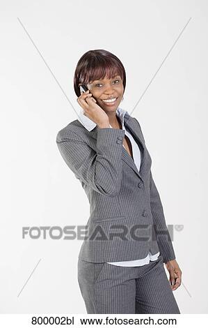Stock Image - portrait of smiling black businesswoman talking on mobile phone. Fotosearch