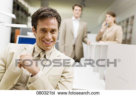 portrait of smiling businessman sitting at desk in office space View Large Photo Image Stock Image - portrait of smiling businessman sitting at desk in office space. Fotosearch