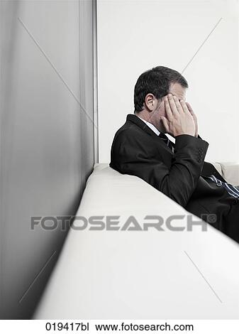 portrait of stressed businessman sitting on sofa View Large Photo Image Stock Image - portrait of stressed businessman sitting on sofa. Fotosearch