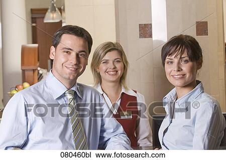 Stock Image - portrait of three smiling members of hotel staff. Fotosearch