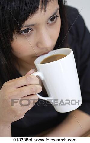 portrait of young asian woman having a coffee break View Large Photo Image Stock Image - portrait of young asian woman having a coffee break. Fotosearch