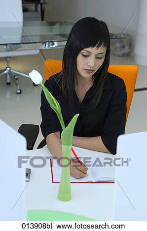 portrait of young asian woman in office space writing notes View Large Photo Image Stock Image - portrait of young asian woman in office space writing notes. Fotosearch