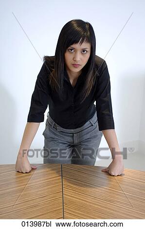 portrait of young asian woman leaning on table in office View Large Photo Image Stock Image - portrait of young asian woman leaning on table in office. Fotosearch