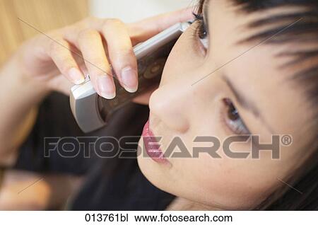 portrait of young asian woman talking on cellular phone View Large Photo Image Stock Image - portrait of young asian woman talking on cellular phone. Fotosearch
