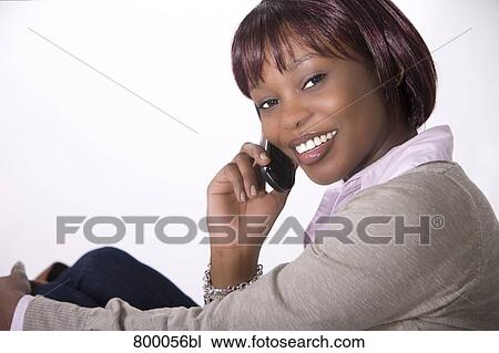 portrait of young black woman talking on mobile phone View Large Photo Image Stock Image - portrait of young black woman talking on mobile phone. Fotosearch