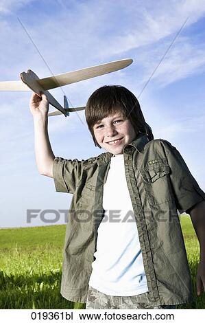portrait of young boy with toy airplane View Large Photo Image Stock Image - portrait of young boy with toy airplane. Fotosearch