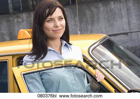 portrait of young business standing at open door of yellow taxi View Large Photo Image Stock Image - portrait of young business standing at open door of yellow taxi. Fotosearch