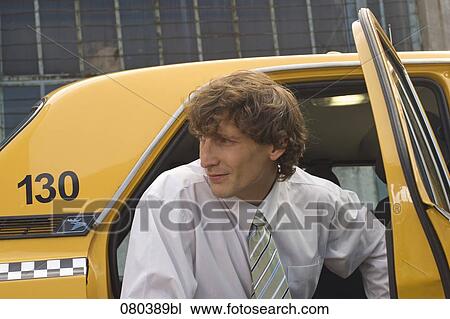 portrait of young businessman leaving yellow taxi View Large Photo Image Stock Image - portrait of young businessman leaving yellow taxi. Fotosearch