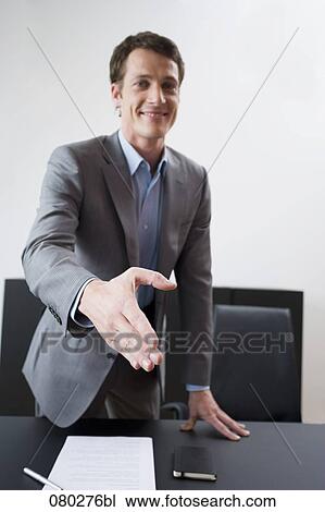 portrait of young businessman reaching out his hand for welcome View Large Photo Image Stock Image - portrait of young businessman reaching out his hand for welcome. Fotosearch