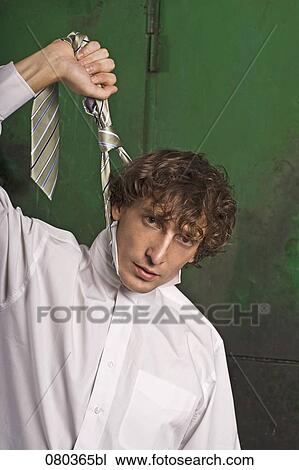 portrait of young businessman strangling himself with tie View Large Photo Image Stock Image - portrait of young businessman strangling himself with tie. Fotosearch
