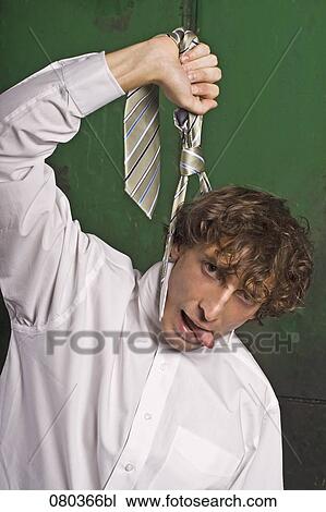 portrait of young businessman strangling himself with tie View Large Photo Image Stock Image - portrait of young businessman strangling himself with tie. Fotosearch