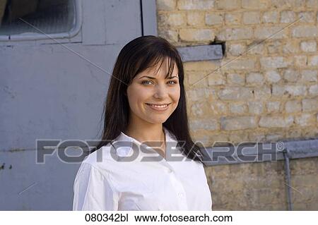 portrait of young businesswoman in front of wall View Large Photo Image Stock Image - portrait of young businesswoman in front of wall. Fotosearch