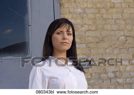 portrait of young businesswoman in front of wall View Large Photo Image Stock Image - portrait of young businesswoman in front of wall. Fotosearch