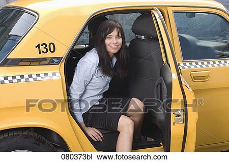 portrait of young businesswoman leaving yellow taxi View Large Photo Image Stock Image - portrait of young businesswoman leaving yellow taxi. Fotosearch